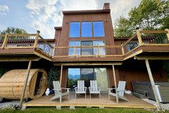 exterior of a guest home featuring a hot tub and sauna on the ground floor