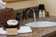 Mountain Top Resort Grand Vista Guest House granite vanity in bathroom with toiletries.