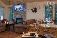 Mountain Top Resort Grand Vista Guest House living room with couch and stone fireplace. flat screen tv mounted on wall.