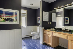 secondary upstairs bathroom with large vanity.