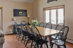 dining area photo at pondview guest home. features large wooden table that seats ten.
