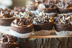 chocolate cupcakes displayed on wooden slabs.