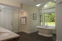Oversized bathroom with freestanding soaking tub, large bay window and walk-in shower.