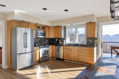 view of kitchen in sunrise guest home featuring a view of the green mountains outside the windows.