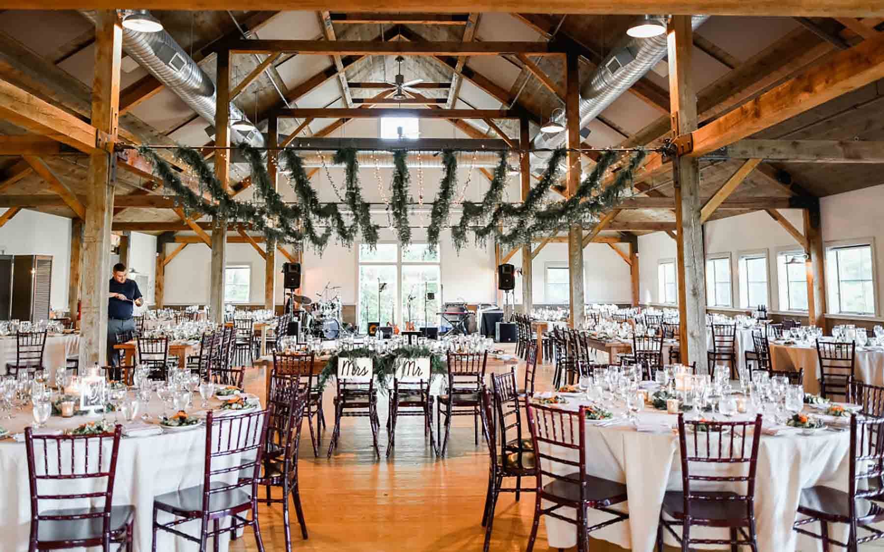 interior of barn decorated for wedding reception