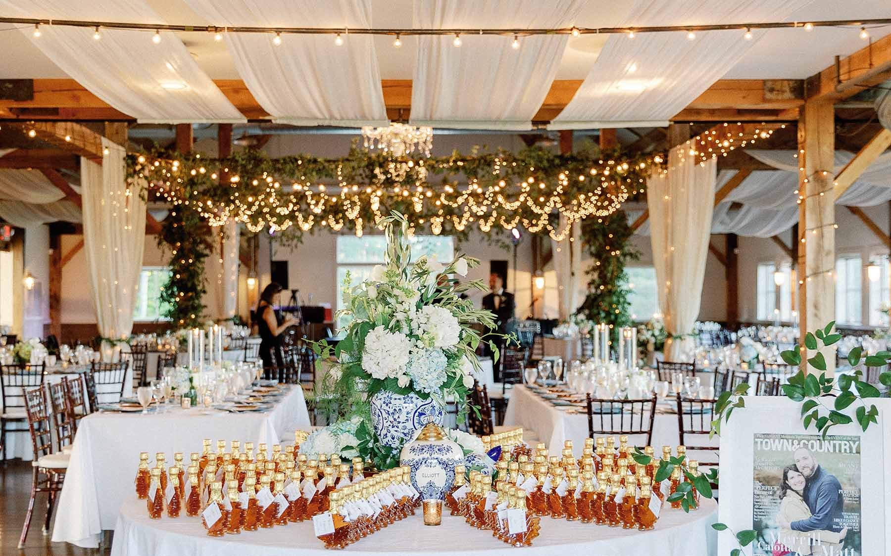Maple syrup spread out on a table with a white linen...event decor in background with white drapery.