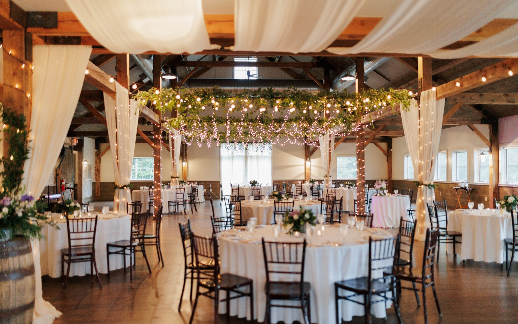 event barn with ribbon drapery and lighting.