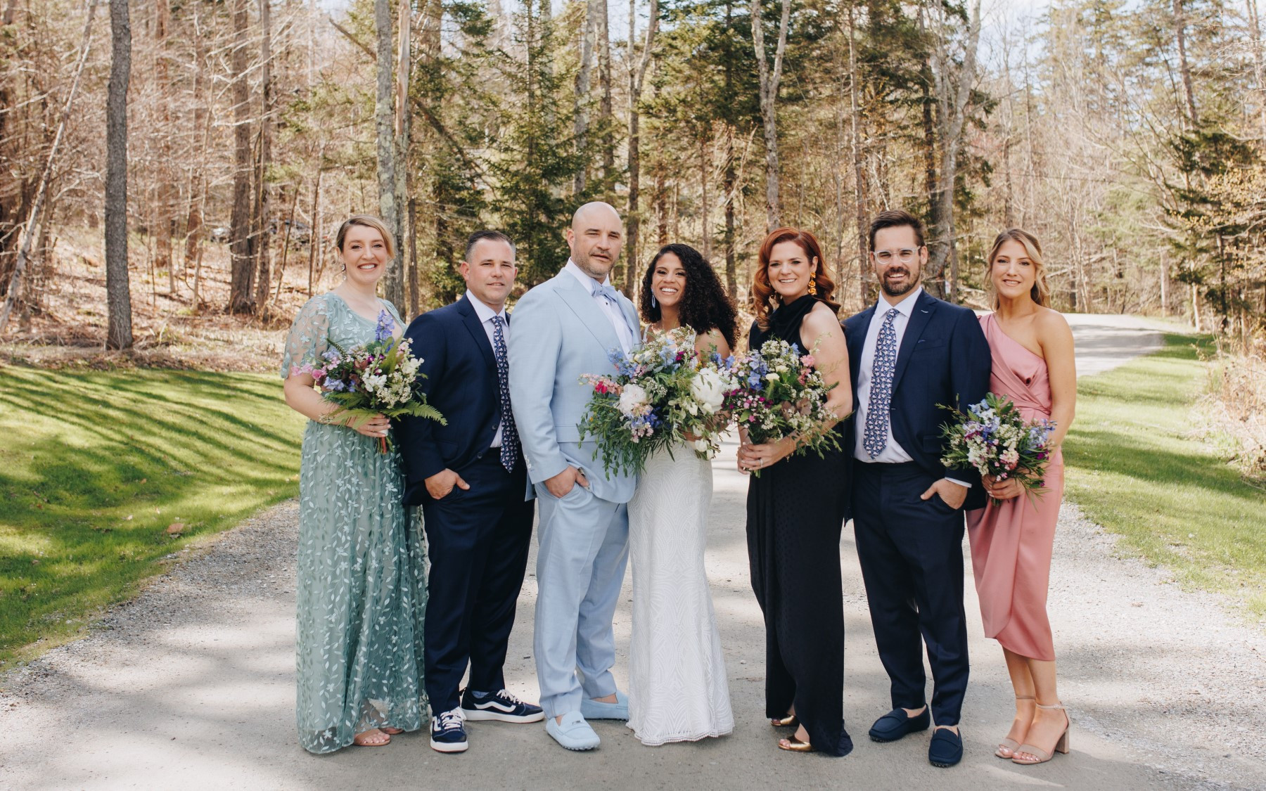 bride and groom featuring bridesmaids and groomsmen holding wildflower bouquets