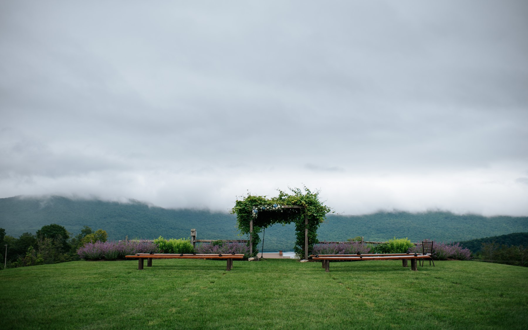 wedding knoll during the summer featuring clouds overlooking the green mountains
