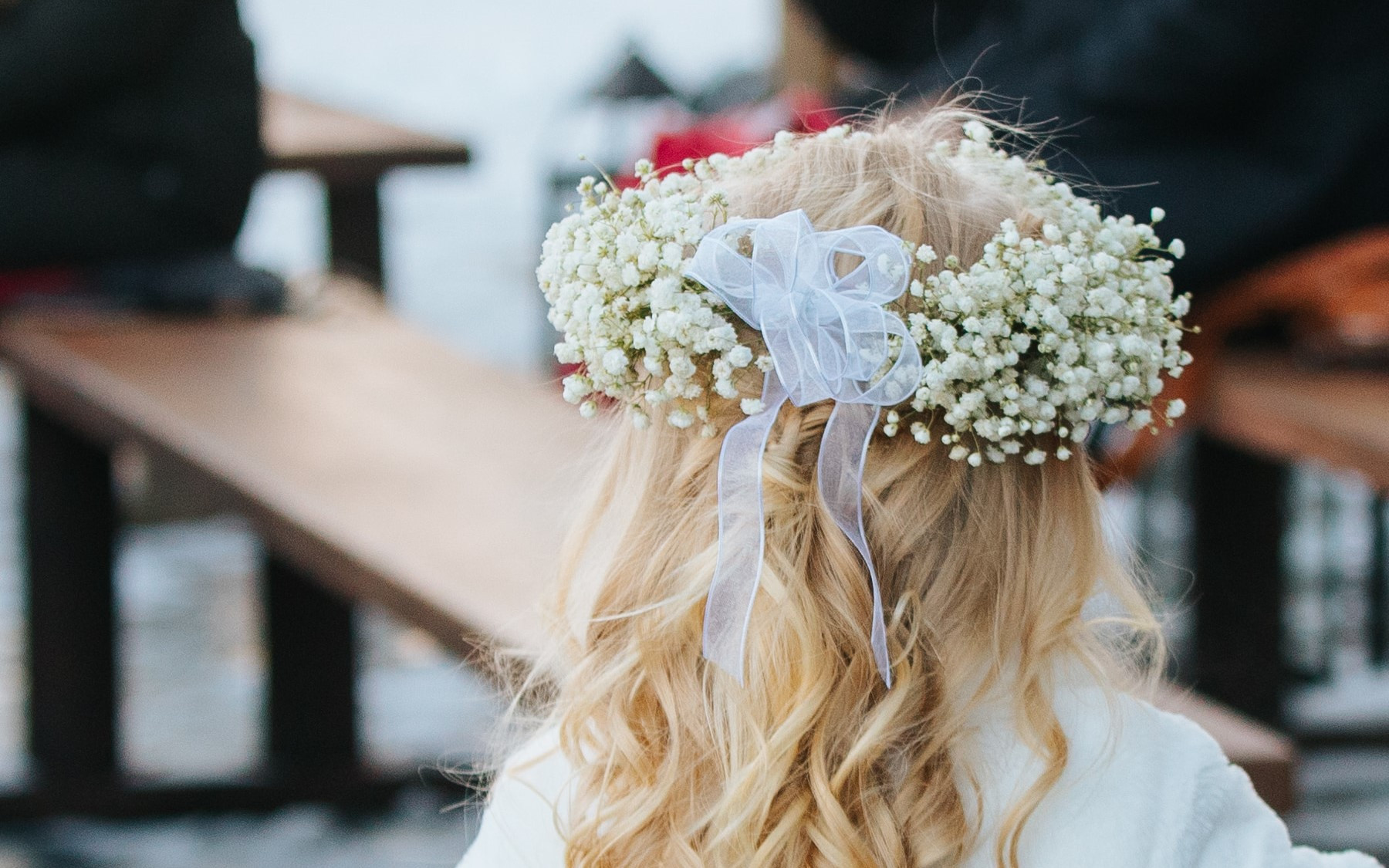 detail photo of flower crown in all white on child's head with blond hair.