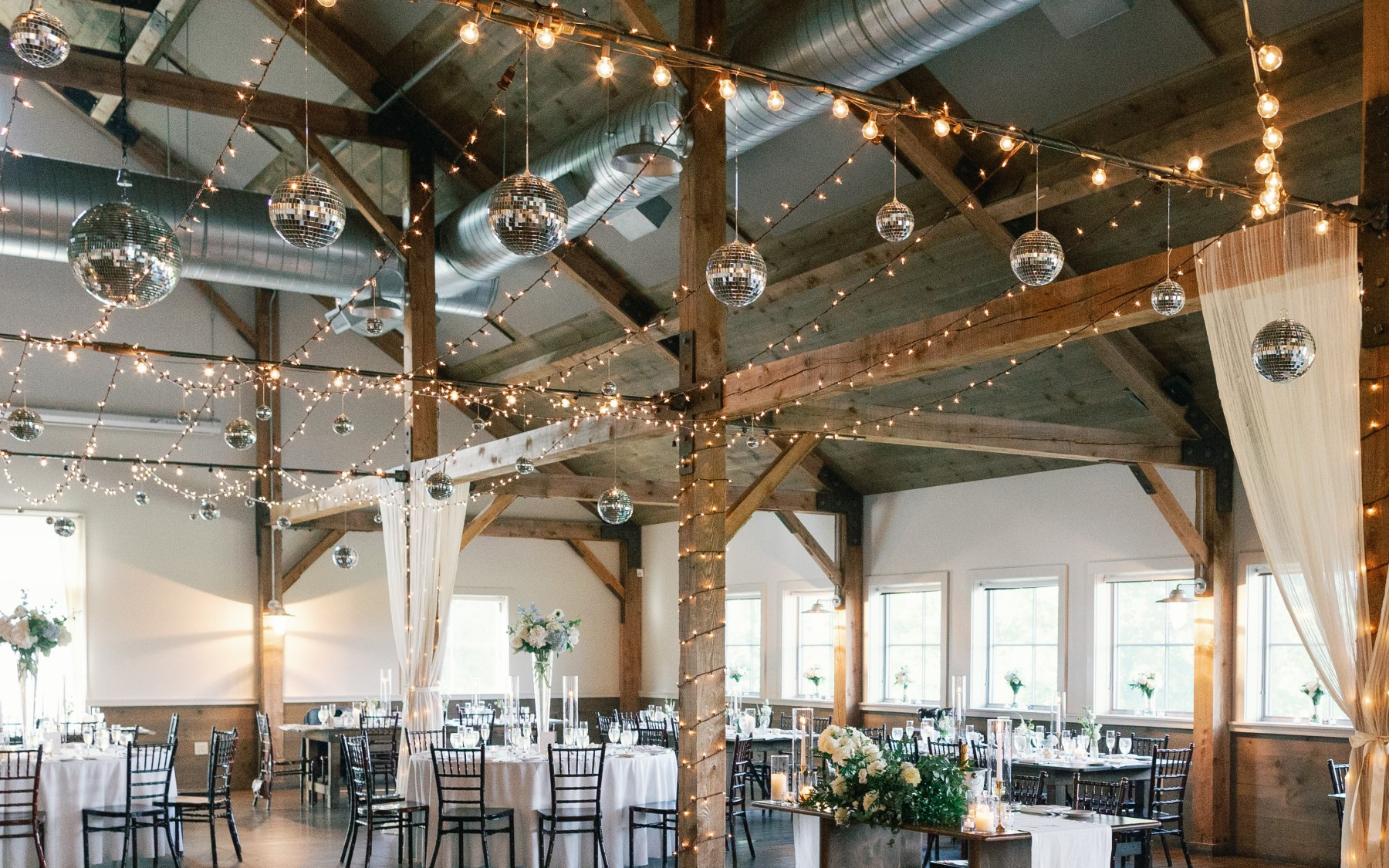 event barn interior with disco balls hanging from ceiling