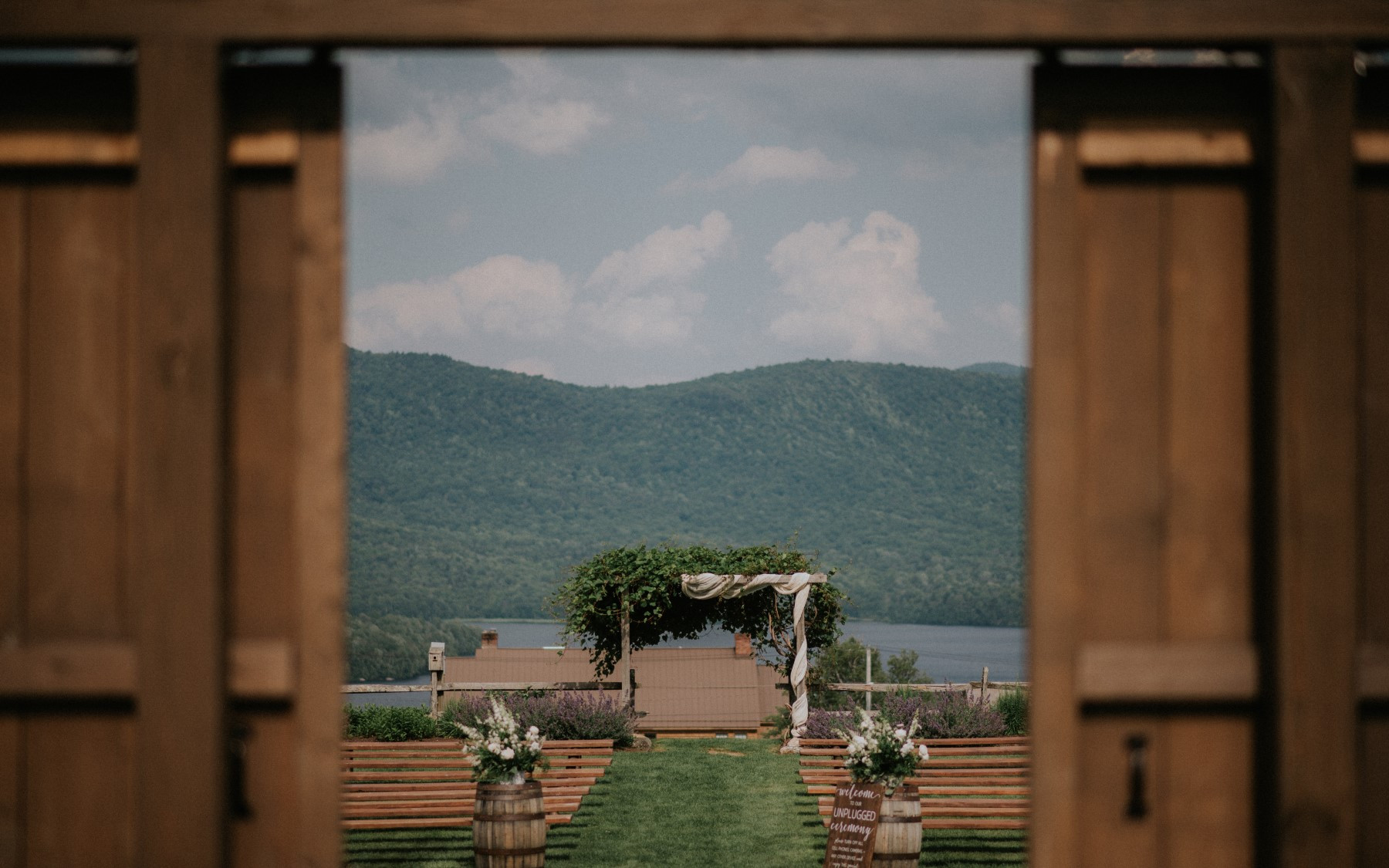 wedding knoll during the summer being looked at through barn doors.