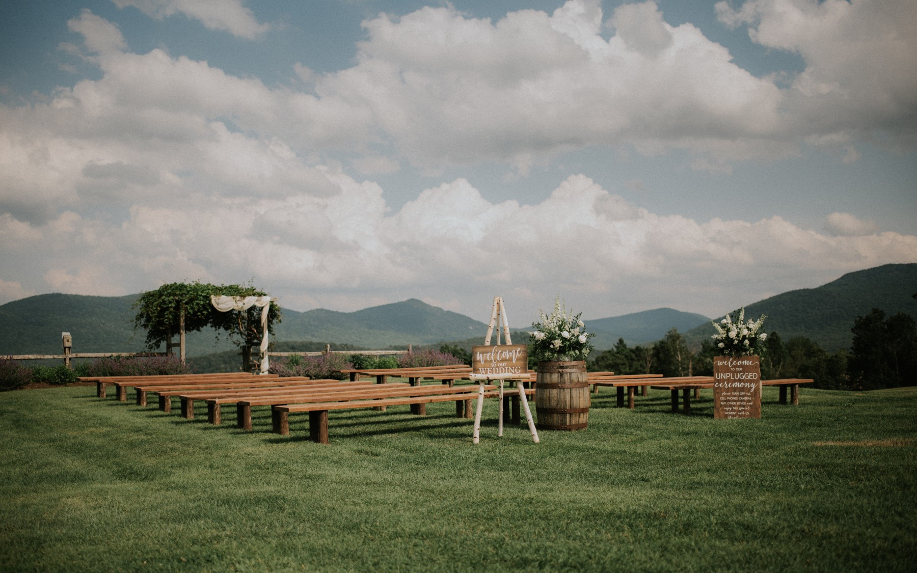 wedding knoll from the side overlooking green mountains in the summer.