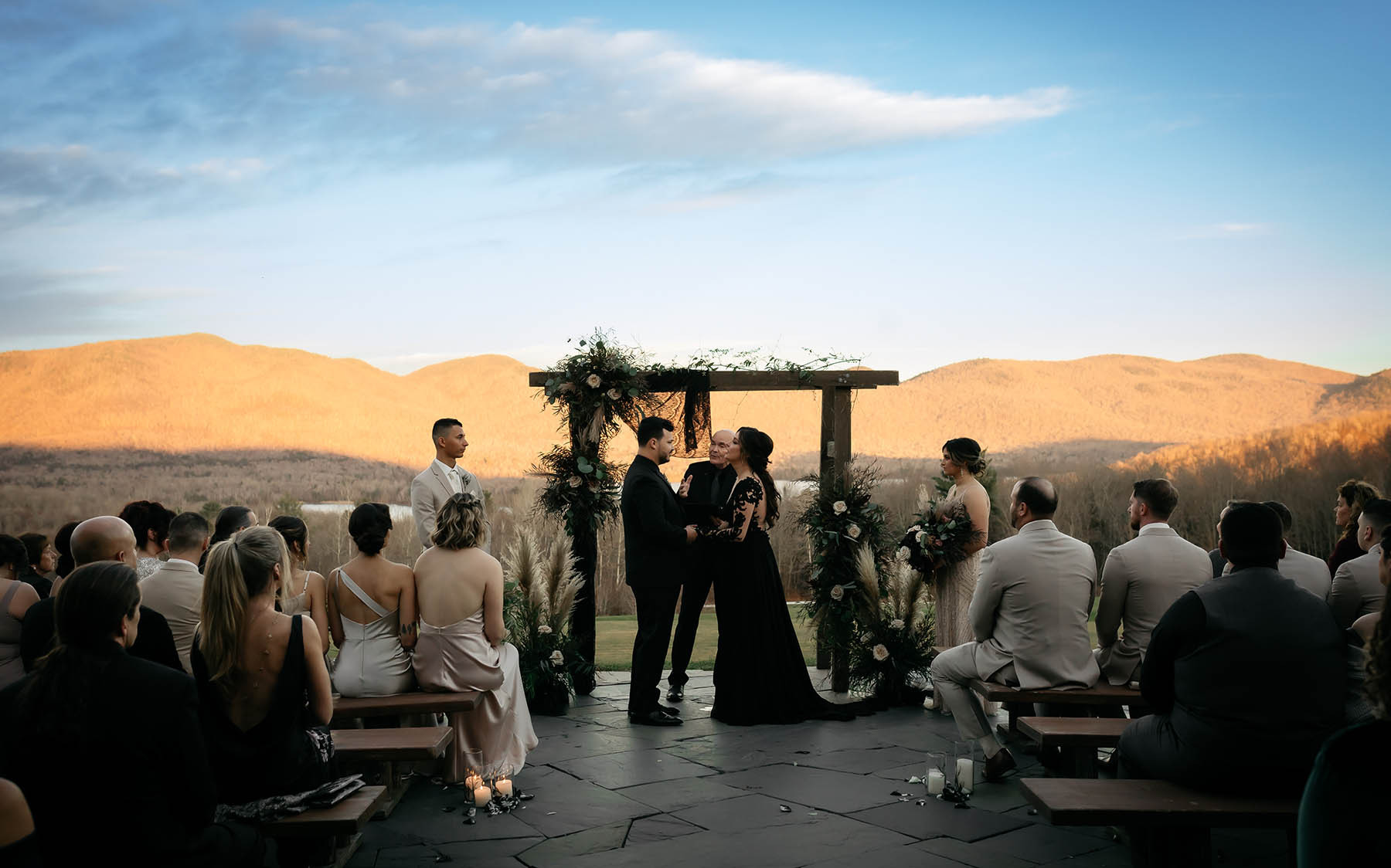Wedding ceremony on patio with mountains in background.