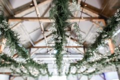 greenery hanging from rafters with exposed wood beams