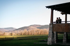 Couple on porch looking at mountains in background