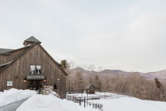 Event barn in the winter featuring a covered pool to the left, overlooking a mountain scene