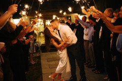bride and groom kissing under sparklers