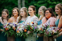 bridesmaids in blue dresses with floral bouquets