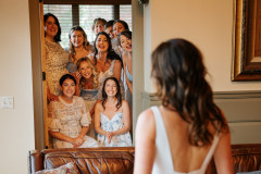 first look photo of bride with bridesmaids.
