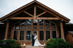 guest house photo of bride and groom kissing on front steps.