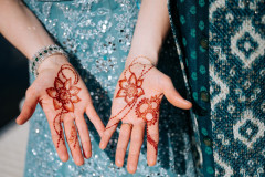 close up photo of henna artwork on bride's hands