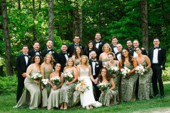 wedding party of a large group in the spring featuring green bridemsaids dresses on 13 bridesmaids and 11 groomsmen with the bride and groom