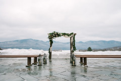 wedding arbor in the winter with a mountainscape in the background.