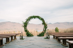 round arbor with greenery facing the green mountains.