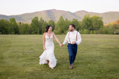 photo of bride and groom running towards camera.