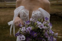 close up of bridal bouquet and details of bride's dress.