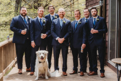 groom standing in center with three groomsmen on each side.