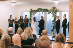 loft wedding in the winter months with a greenery covered birch arbor.