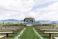 view of wedding knoll with farmhouse benches overlooking mountains.