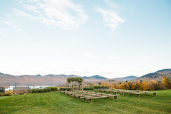 view of the wedding knoll looking out with the inn, lake, and mountains in the background.