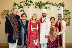 indian baesd wedding ceremony photo of bride and groom with parents.