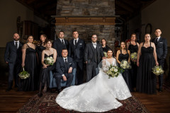 bride and groom with wedding party in dramatic portrait.