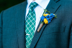 Suit with green striped tie with blue and yellow flower pin at Mountain Top Inn & Resort in Chittenden, VT