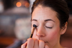 close-up photo of brunette woman having make-up done.