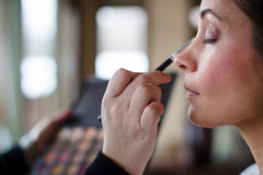 close-up photo of brunette woman having make-up done.
