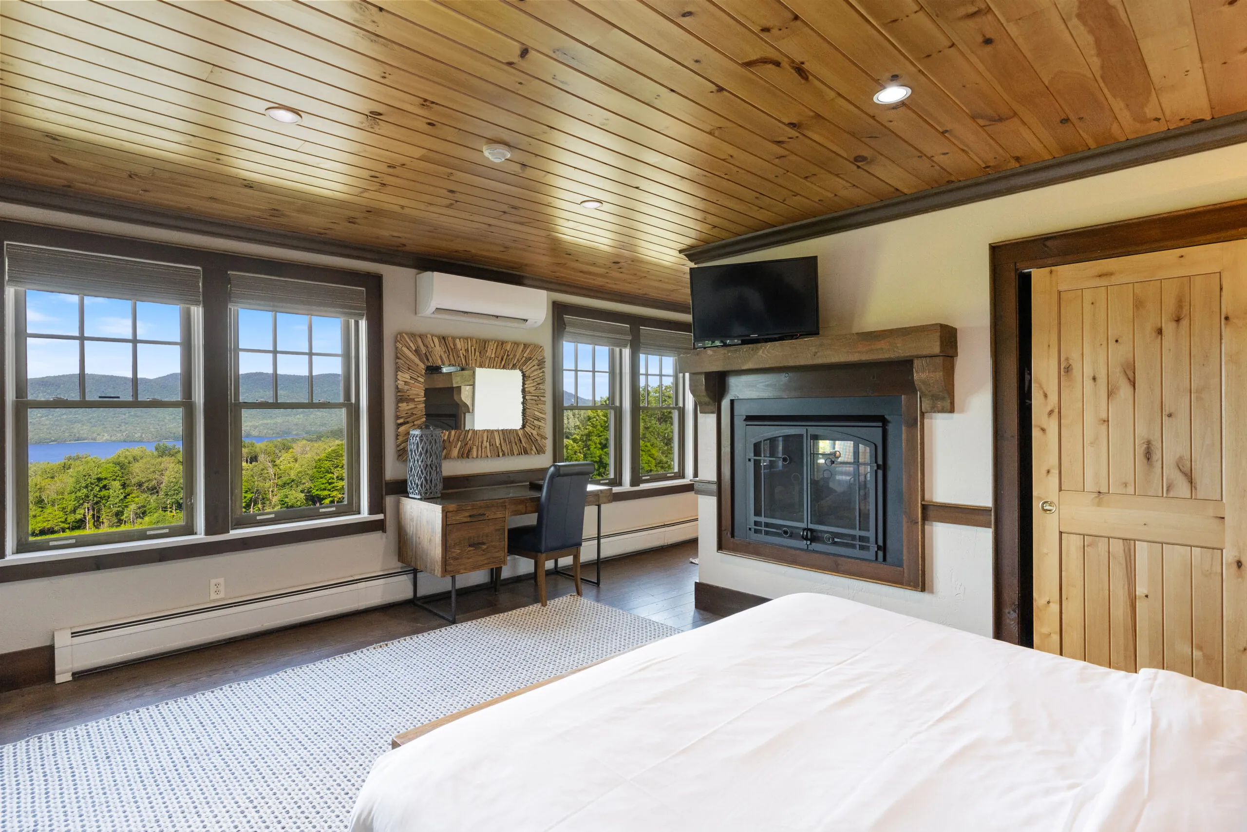 photo of guest room featuring large windows and desk.